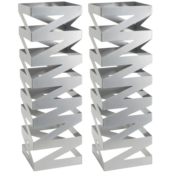Two silver metal Front of the House Zig Zag display risers with a zigzag pattern.