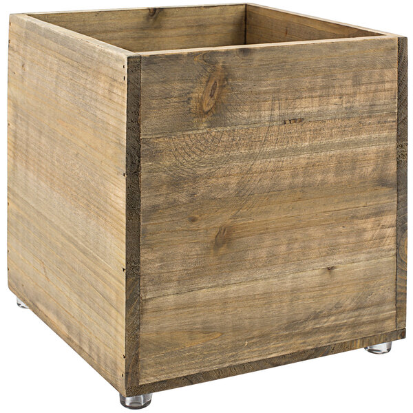 A Room360 natural wood cube riser with a clear bottom.