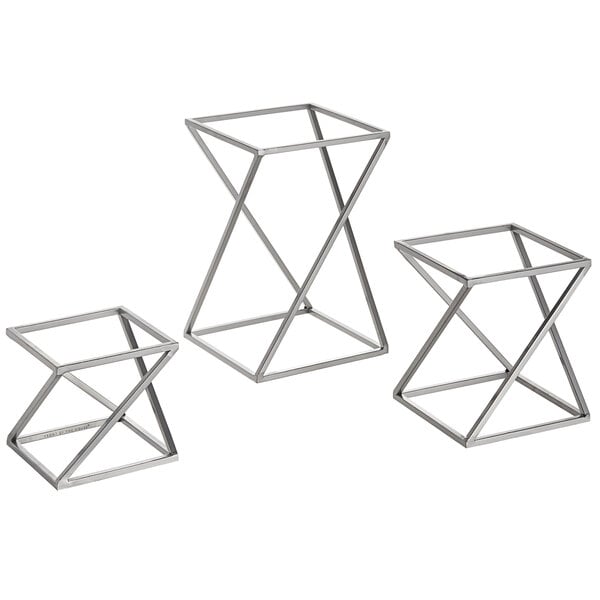 A group of three metal geometric stands.
