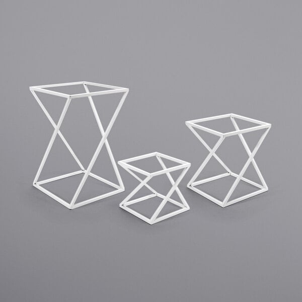 A group of white geometric display risers.