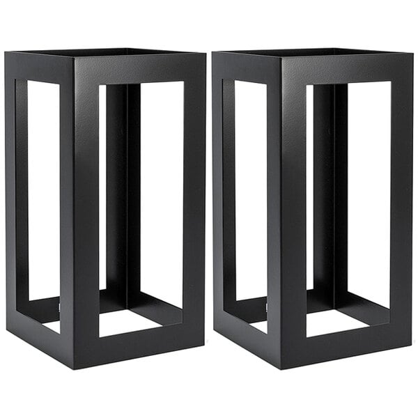 Two black square stainless steel risers on a table.