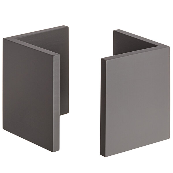 Two grey bamboo L-shape risers on a grey surface.