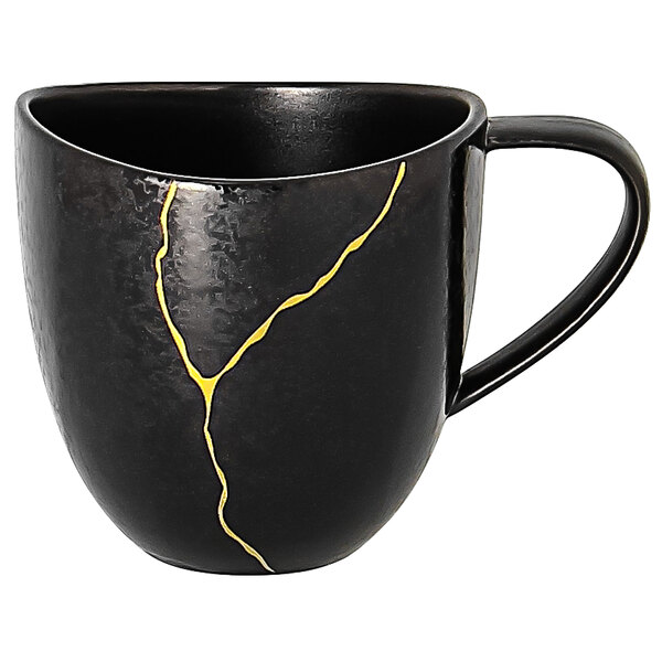 A black porcelain coffee cup with gold lines and a yellow crack.