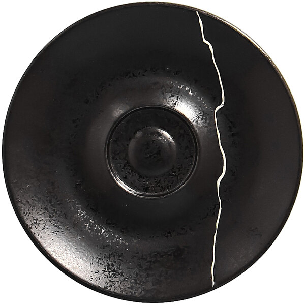 A black porcelain saucer with a silver crack in the middle.