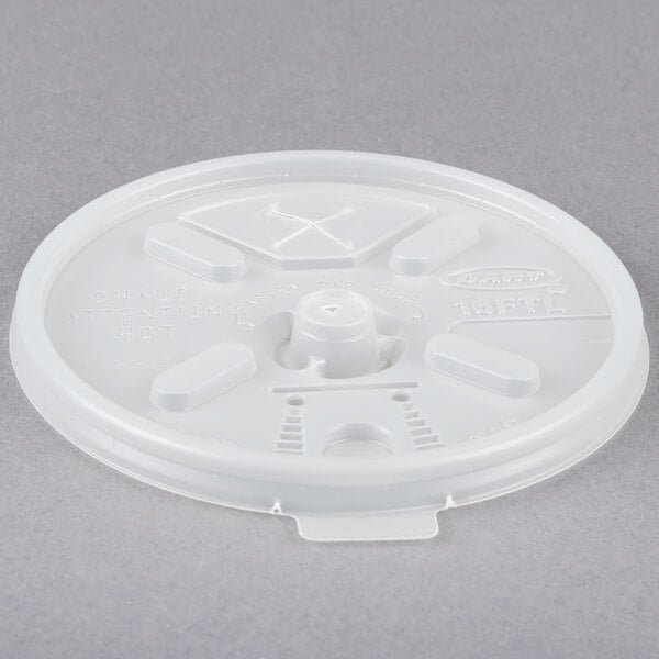 A white translucent plastic lid with a straw slot and a cross on top.