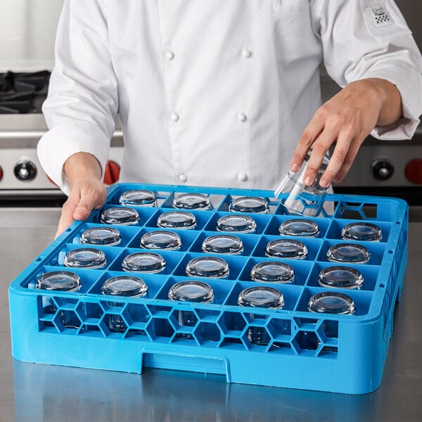A chef using a Carlisle Opticlean glass rack to hold glasses.