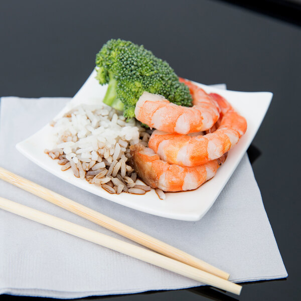 An Arcoroc square porcelain plate with shrimp, rice, and broccoli on it.