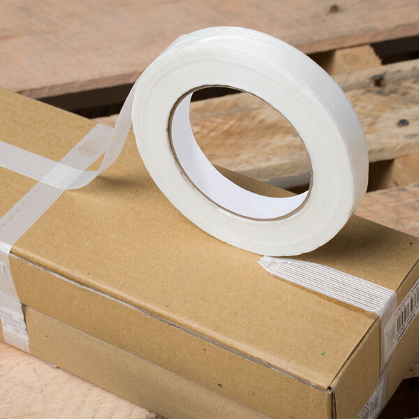 A box with a roll of Shurtape General Purpose Fiberglass Reinforced Strapping Tape on it.