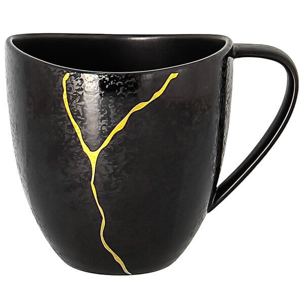 A black RAK Porcelain Kintzoo mug with gold lines on it.