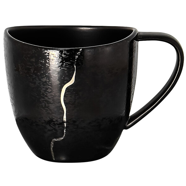 A black RAK Porcelain Kintzoo porcelain cup with silver detail and a crack in the middle.