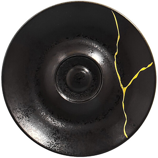 A black RAK Porcelain saucer with a gold crack in it.