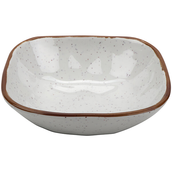 A white melamine bowl with brown speckled edges.