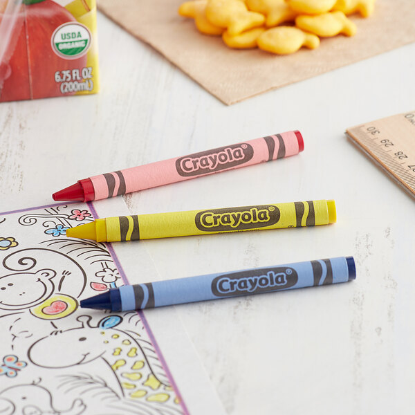 A group of Crayola Classic assorted crayons in cello wrap on a table.