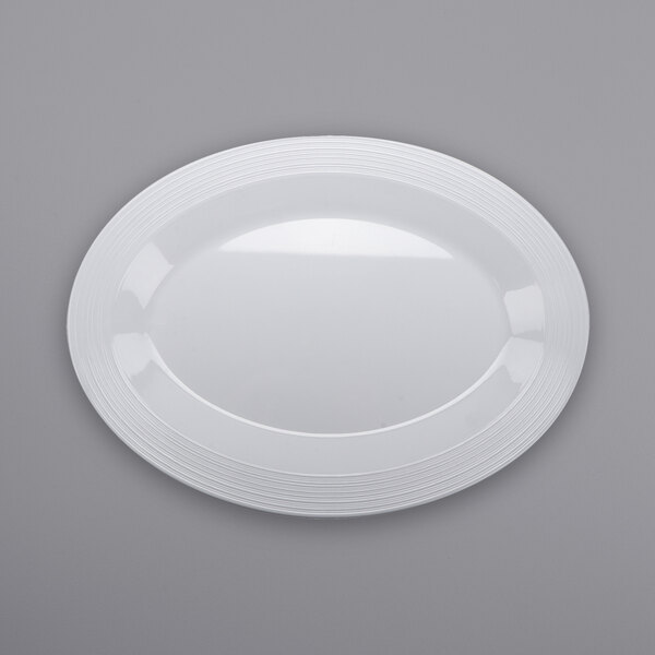 A white oval melamine platter with textured rims.