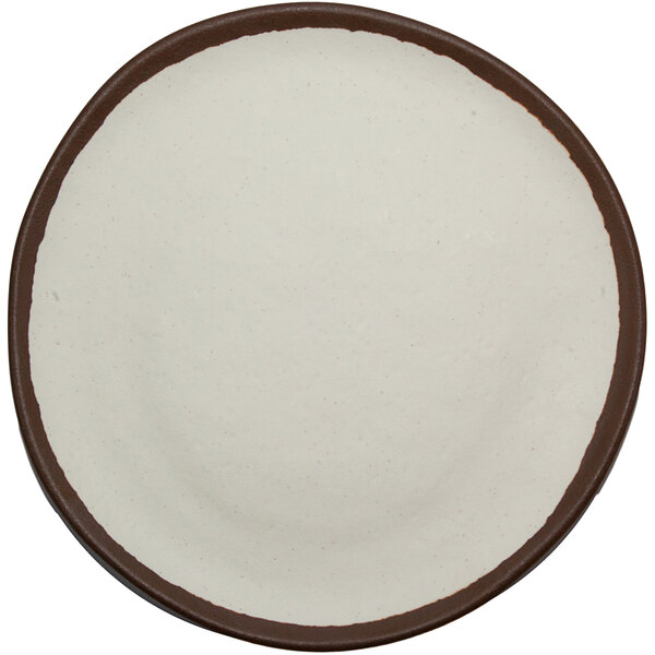 A white plate with brown trim.