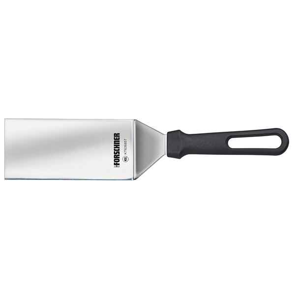 A Victorinox stainless steel turner with a black handle.