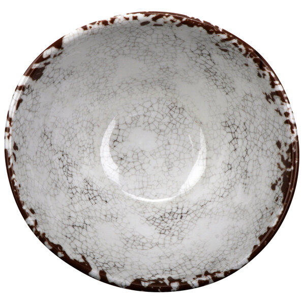 A white melamine bowl with brown speckles.