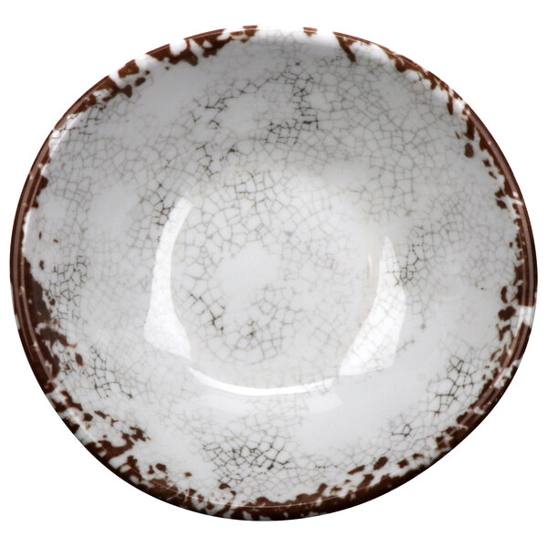 A white melamine bowl with brown irregular edges.