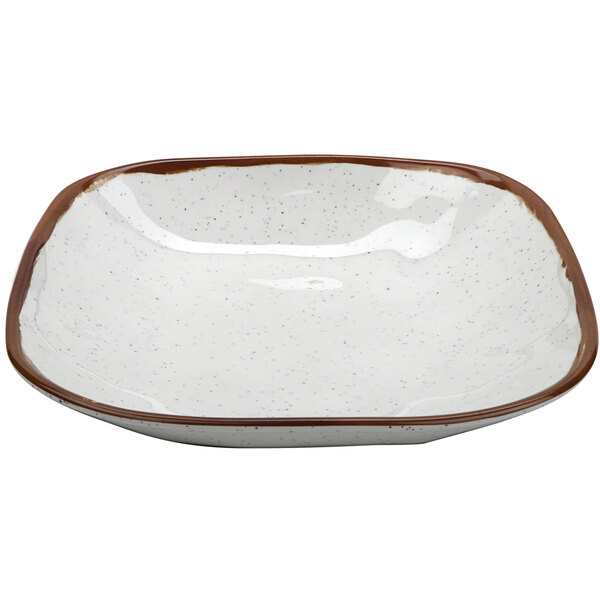 A white melamine bowl with brown speckles and a brown rim.