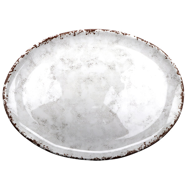 A white oval melamine platter with brown speckled edges.