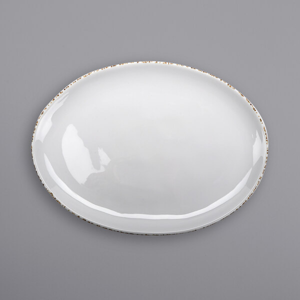 A white oval plate with brown speckled trim.