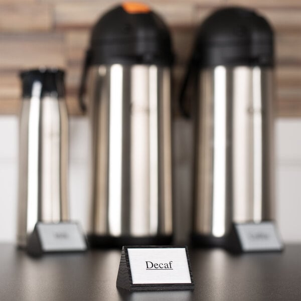 A white wood "Decaf" sign on a table.