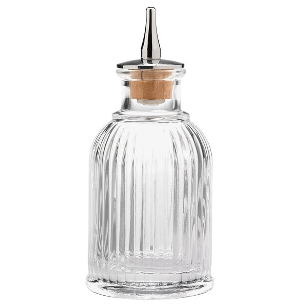 A Barfly ribbed clear glass bitters bottle with a metal lid.