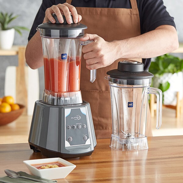 A person using an AvaMix commercial blender to make a smoothie.
