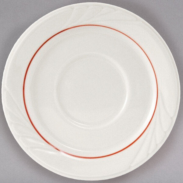 A white Tuxton saucer with a white rim and red lines around the edge.