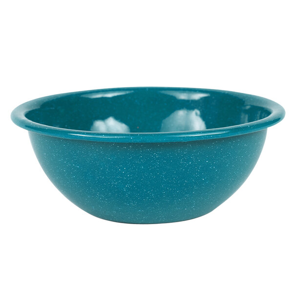 A close-up of a turquoise Crow Canyon Home Stinson enamelware bowl with a speckled surface.