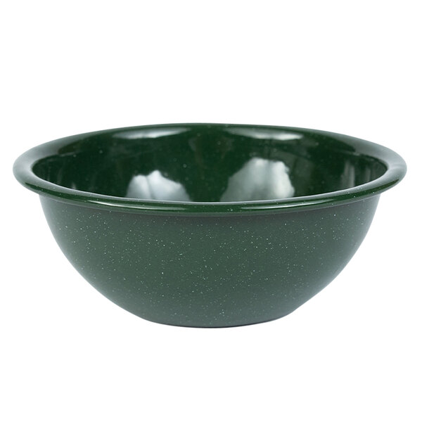 A Crow Canyon Home Stinson enamelware bowl in forest green with a speckled surface and white rim.