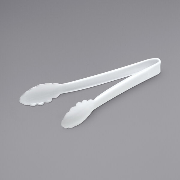 A pair of white Fineline plastic serving tongs with scalloped edges.