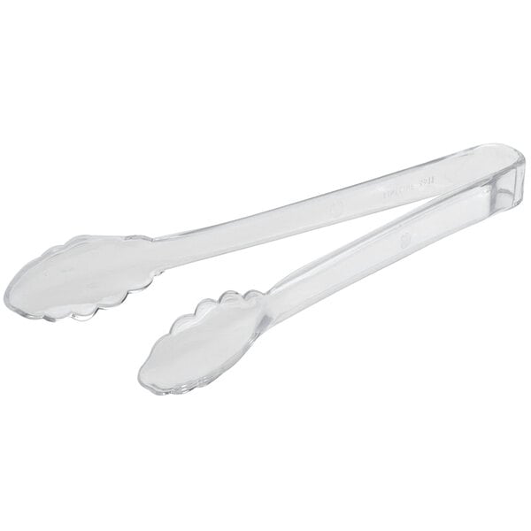 A pair of clear tongs with scalloped edges.