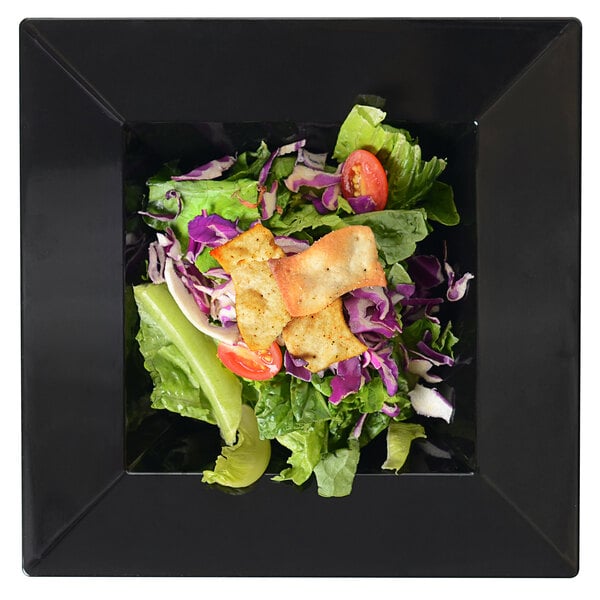 A Fineline Settings black square bowl filled with salad.