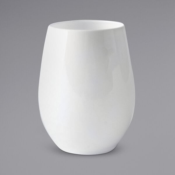A white Fineline plastic stemless wine glass on a gray surface.