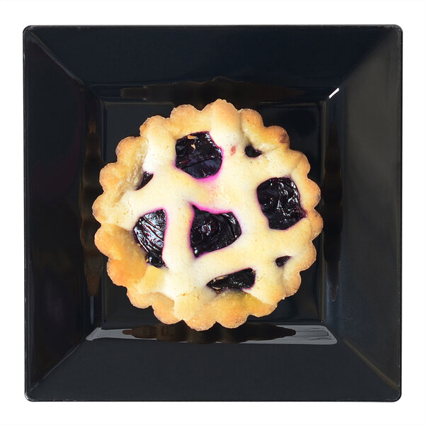 A small blueberry pie on a Fineline Settings black square cocktail plate.