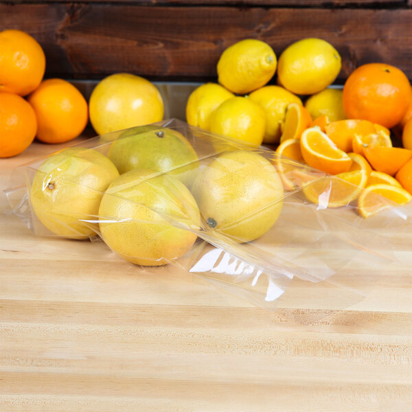 A table with a group of oranges and lemons in LK Packaging plastic bags.