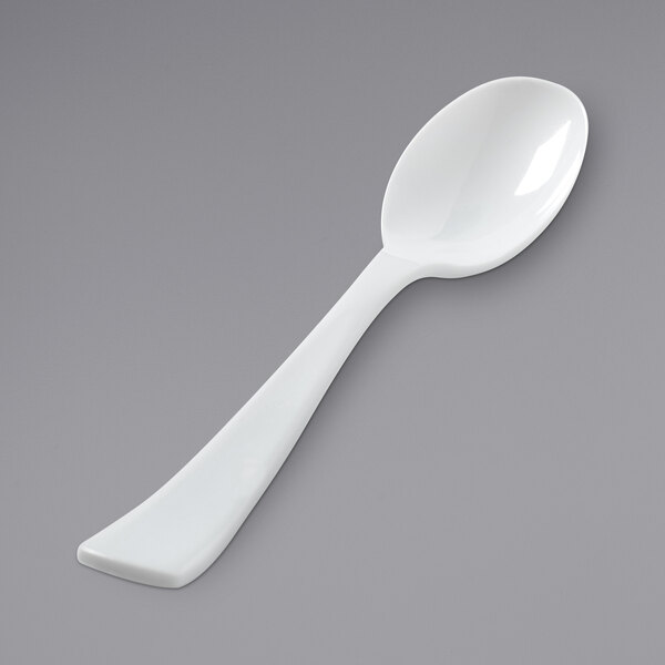 A close-up of a Fineline white plastic serving spoon.
