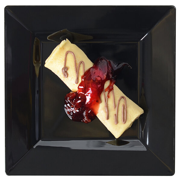 A Fineline Settings black square dessert plate with food on it.