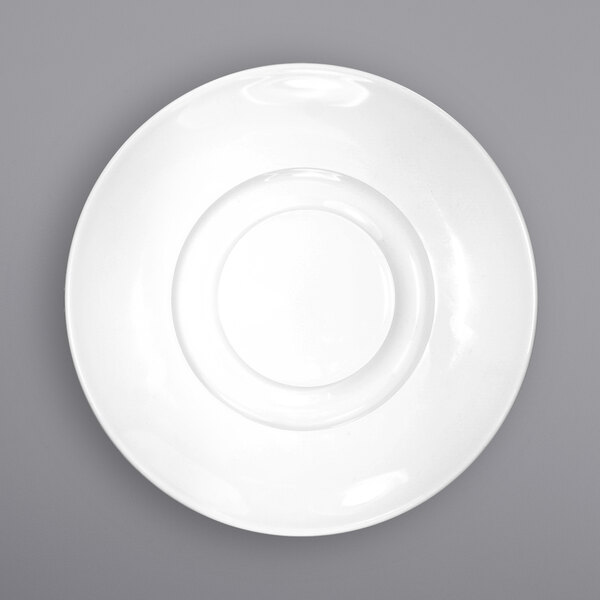 A close-up of an International Tableware Bristol bright white porcelain saucer with a circular center.