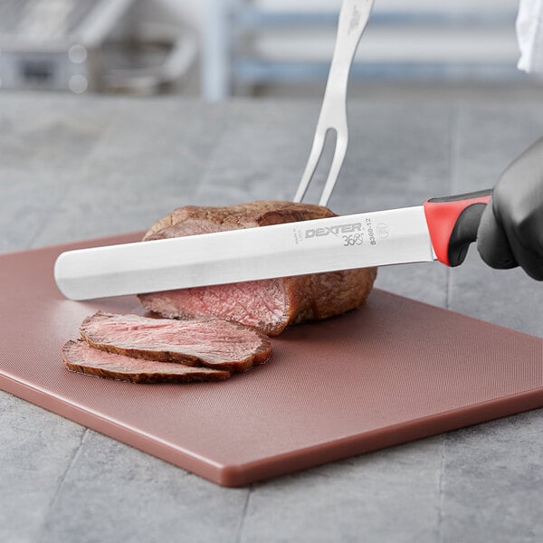 A person using a Dexter-Russell 360 Series slicing knife to cut meat on a cutting board.