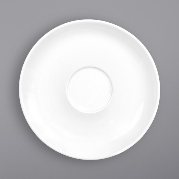 A bright white porcelain saucer with a hole in the middle.