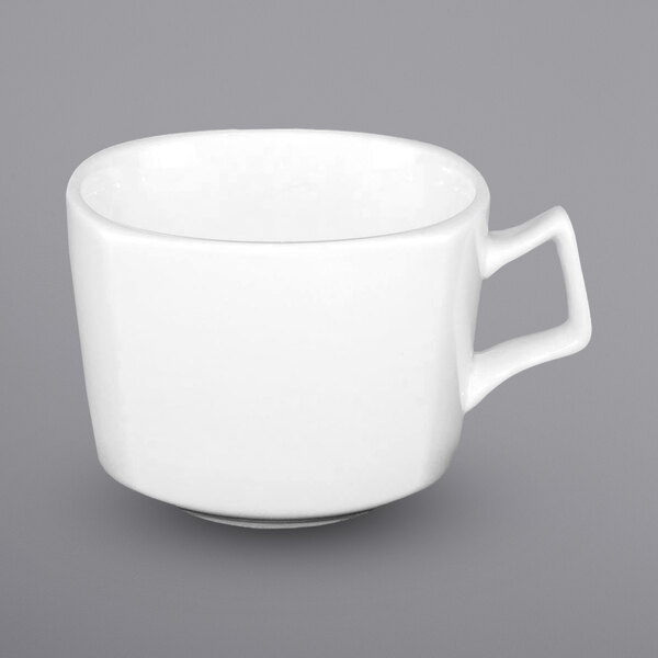 A close up of an International Tableware white porcelain cup with a handle.