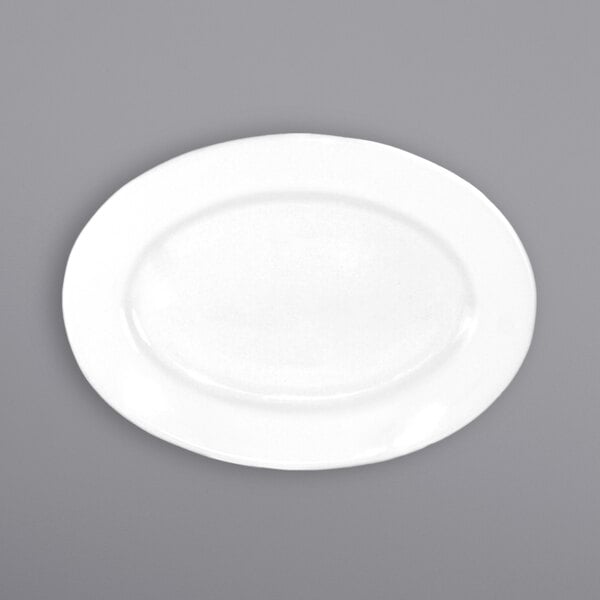 An International Tableware Dover white porcelain oval platter with a wide rim.