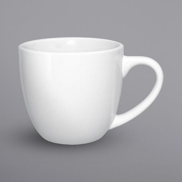 A white porcelain International Tableware Dover cappuccino cup with a handle.