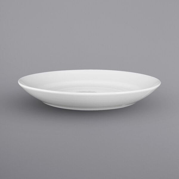 A close up of a white International Tableware porcelain stadium bowl with a small rim.