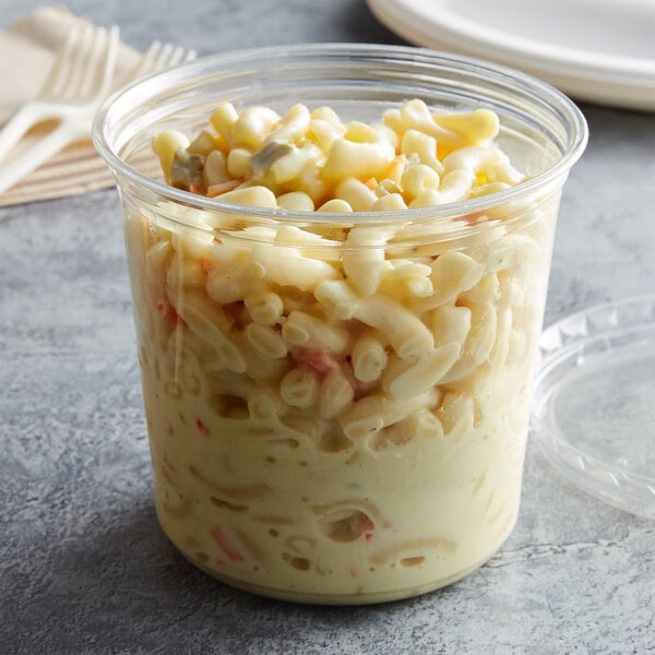 A Fabri-Kal clear plastic deli container filled with macaroni and cheese.