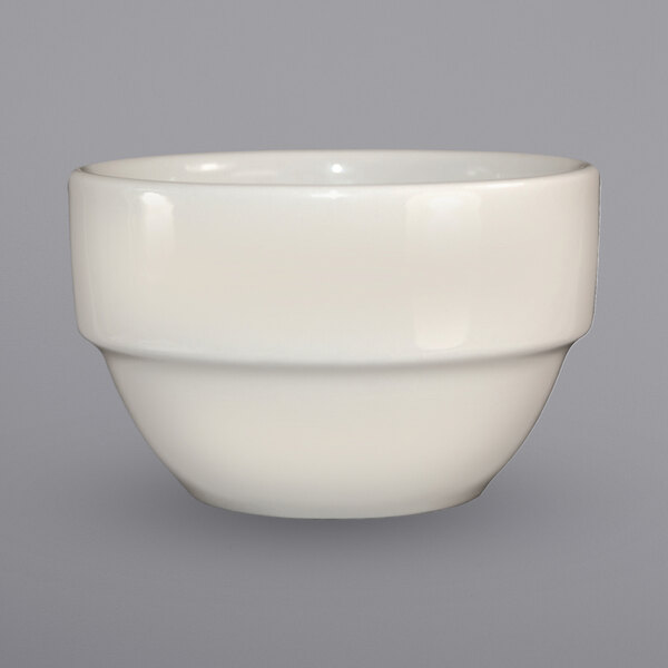 An ivory stoneware bowl with a rounded bottom on a white background.