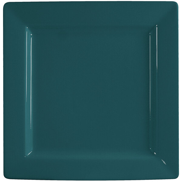 A square porcelain plate with a blue surface and blueberry edge.