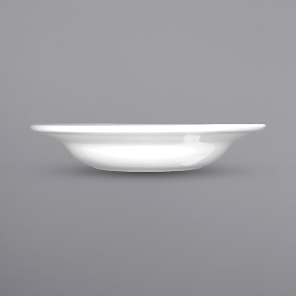A close up of an International Tableware Dover porcelain soup bowl with a wide rim.
